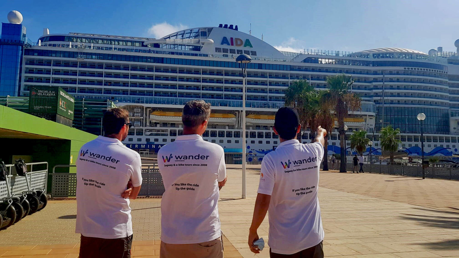 Wander Cartagena guides in front of a cruise ship at the Cartagena terminal